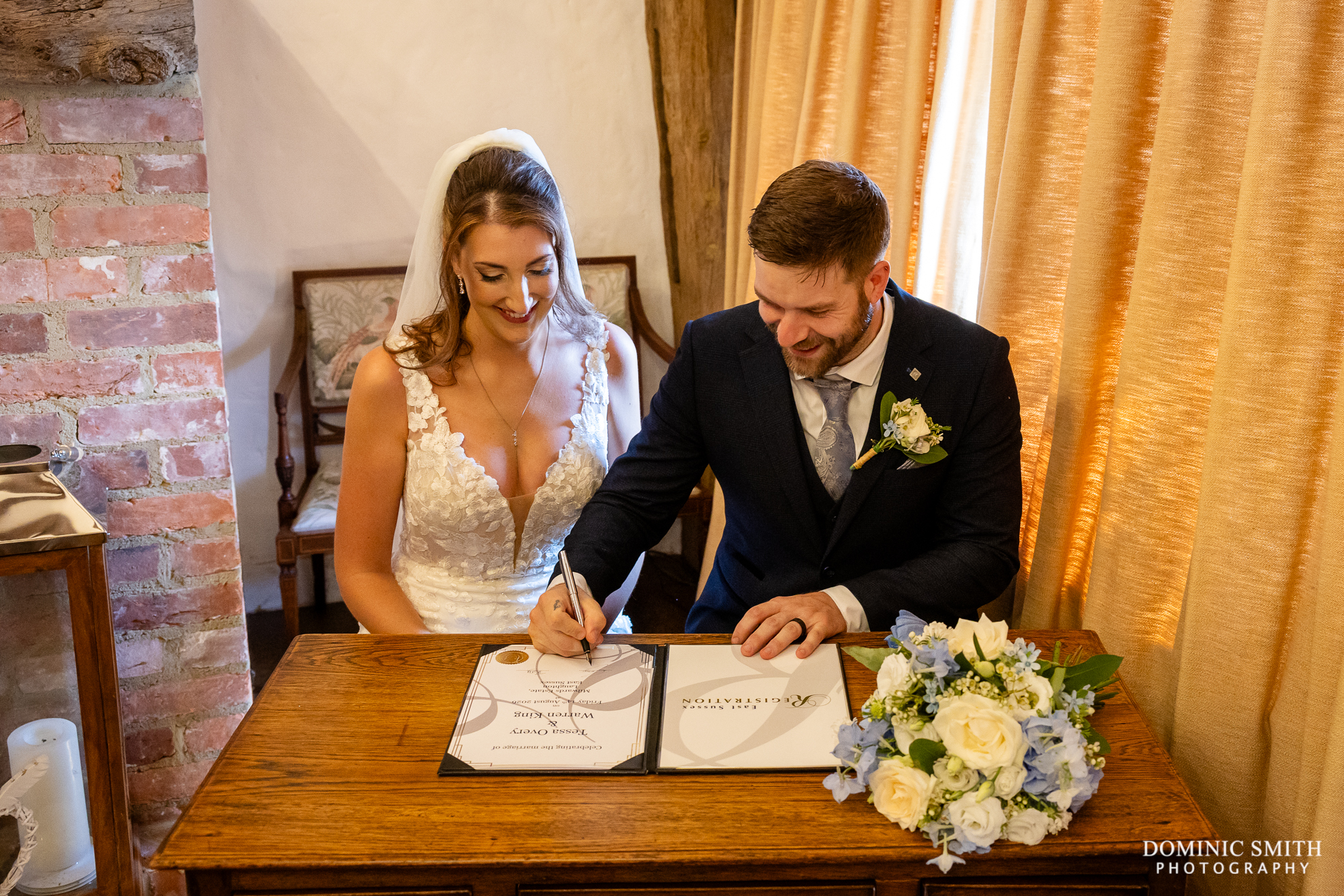 Signing the wedding register at Millwards