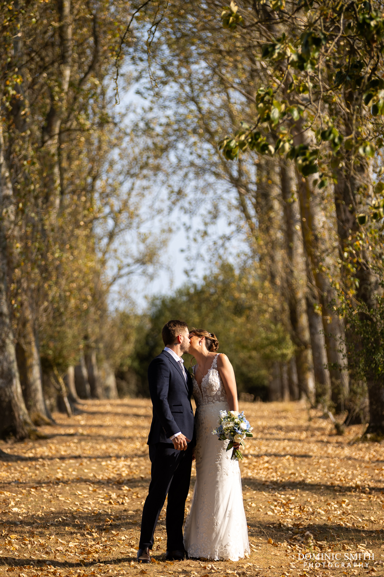 Bride and Groom walking down the Millwards Tree Lined Avenue